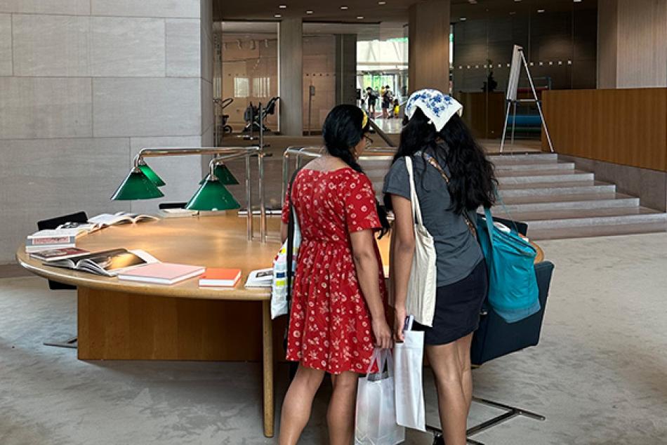Visitors looking at books on display in the National Gallery of Art Library.