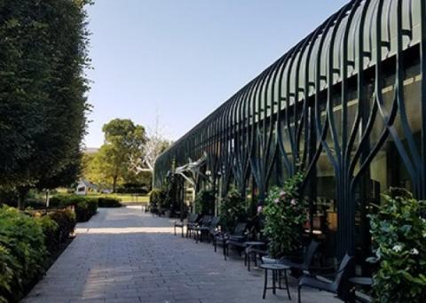 The front entrance to the National Gallery's Pavilion Café lined with tables and chairs.
