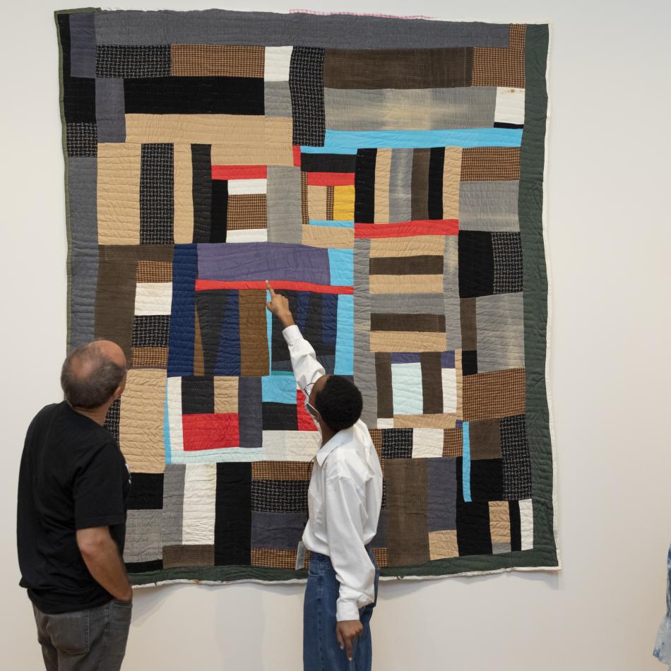 Interns examine a Gee's Bend quilt with a curator