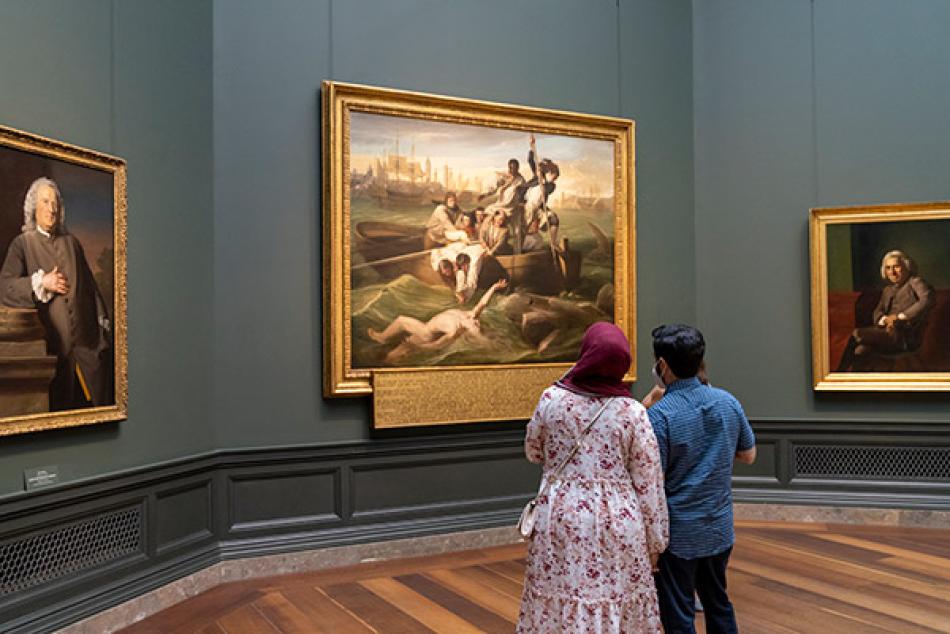 Visitors enjoy artwork in the National Gallery's West Building.