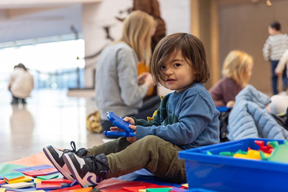 A young visitor plays in our children's area during a First Saturday program.