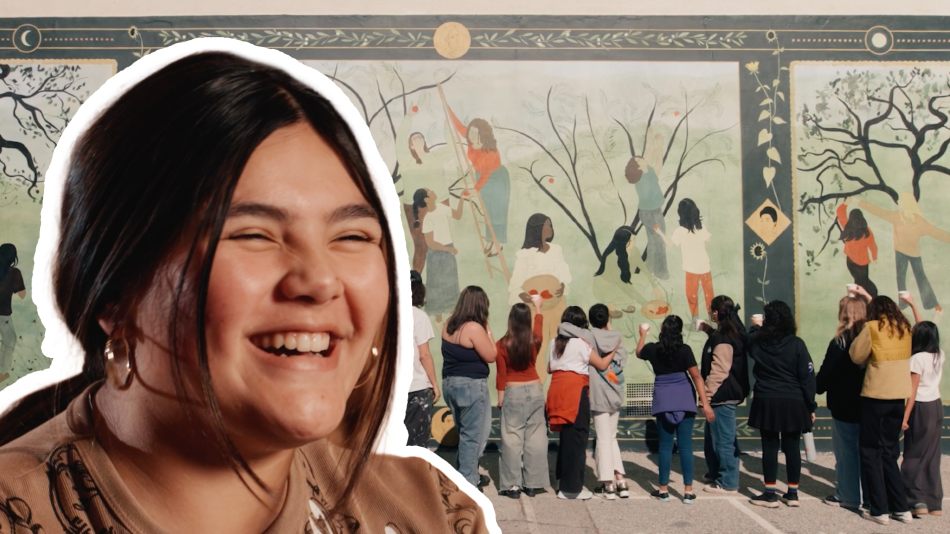 A student smiles in front of a painted mural at Altadena Elementary School